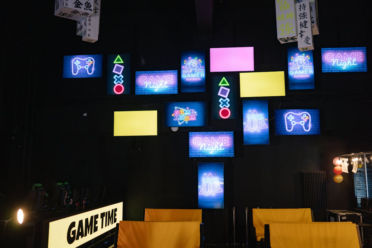 services-03 A lively gaming room displaying bright neon signs and screens, creating an immersive atmosphere.